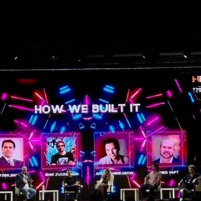 He is sitting in a chair alongside other people.